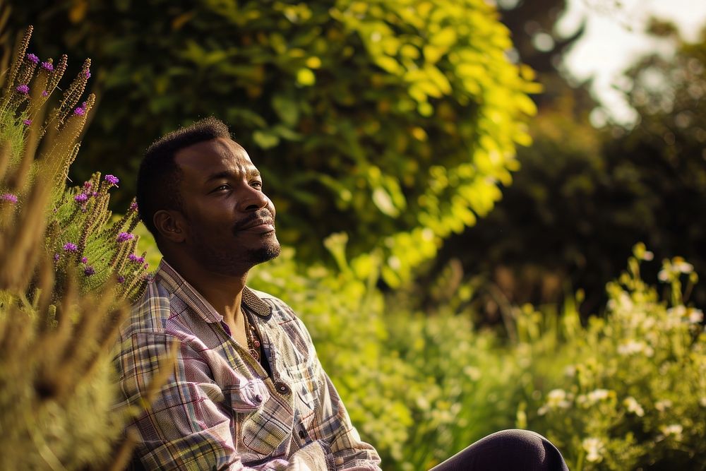 Black man portrait sitting outdoors.