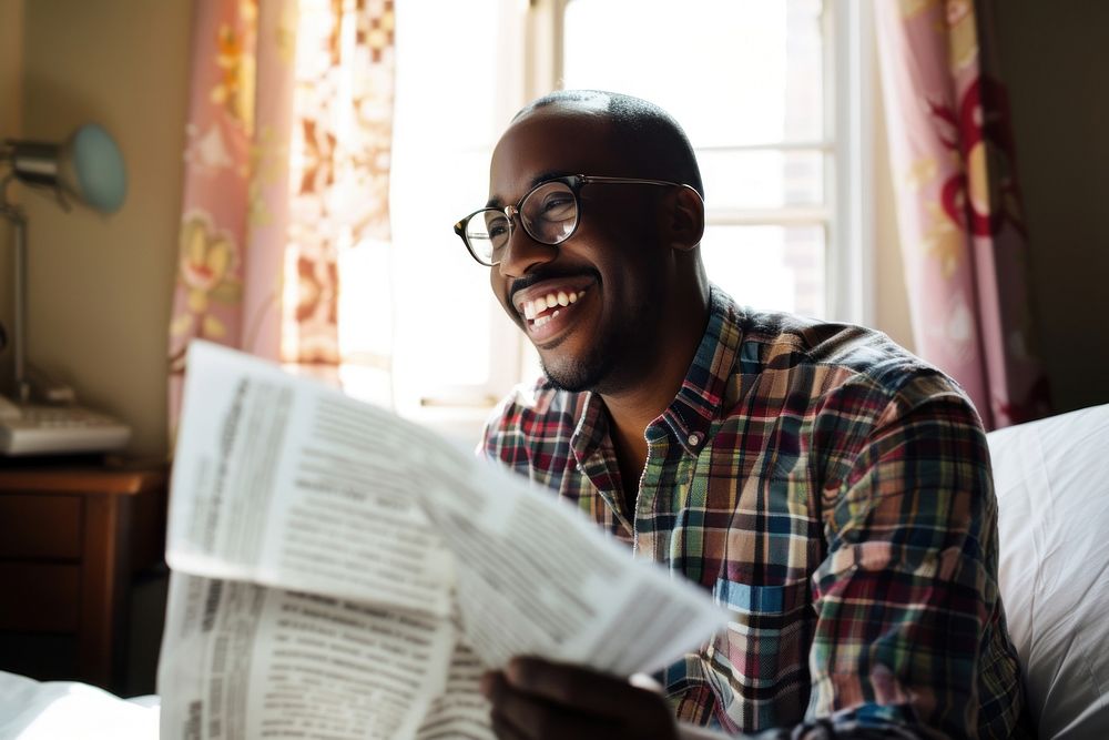 Black man portrait glasses reading.