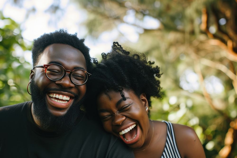 Black couple laughing portrait glasses.