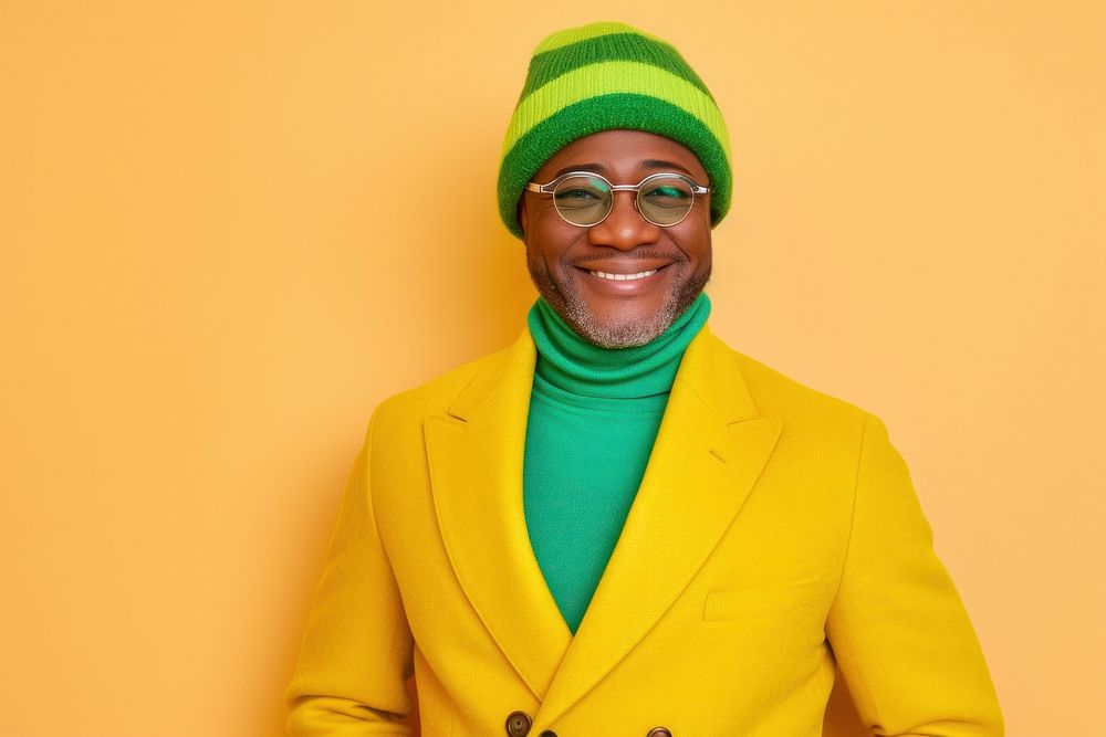 Cool old black man with fashionable clothing style full body on colored background portrait glasses scarf.