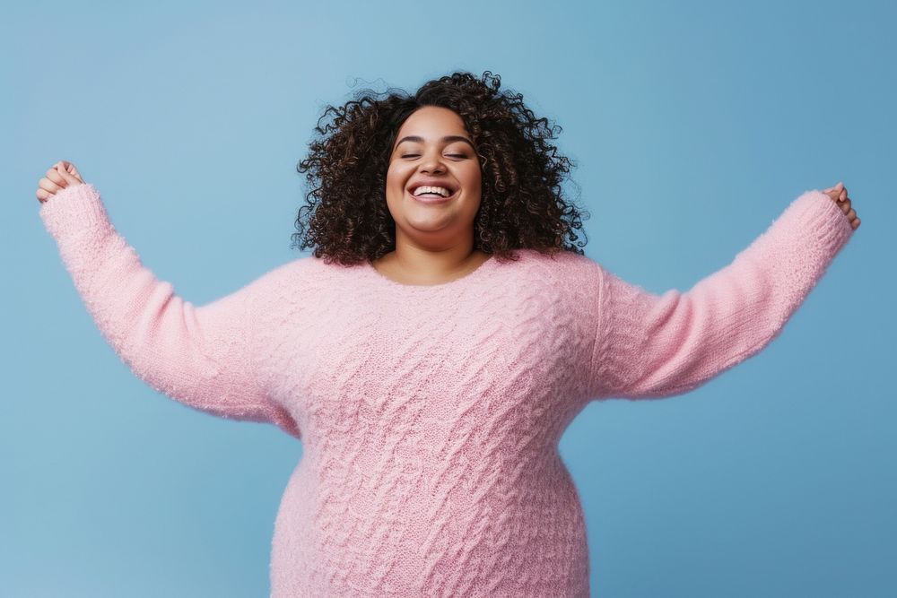 Cool chubby young black woman with fashionable clothing style full body on colored background laughing sweater fun.
