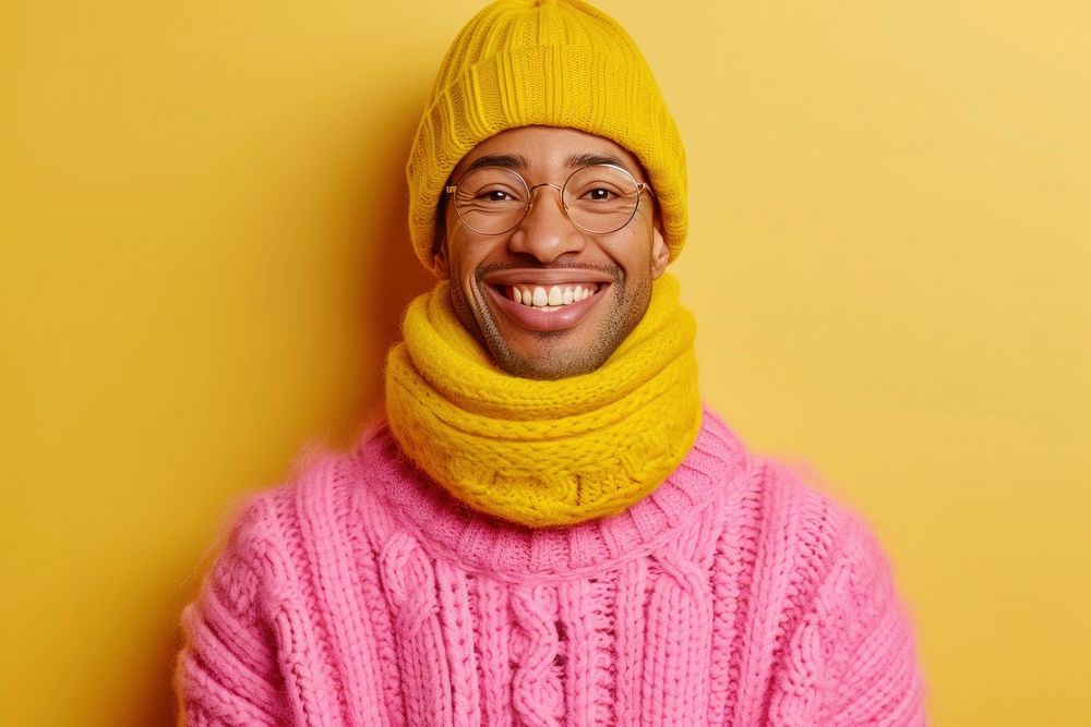 Cool senior black man with fashionable clothing style portrait on colored background laughing sweater scarf.