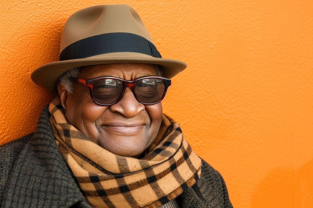 Cool senior black man with fashionable clothing style portrait on colored background glasses scarf adult.