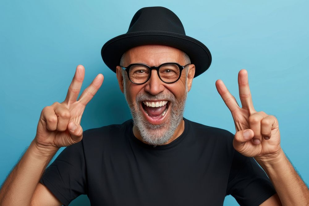 Cool senior black man with fashionable clothing style portrait on colored background shouting laughing adult.