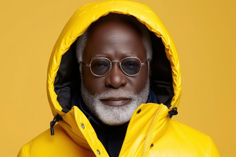 Cool senior black man with fashionable clothing style portrait on colored background glasses adult male.