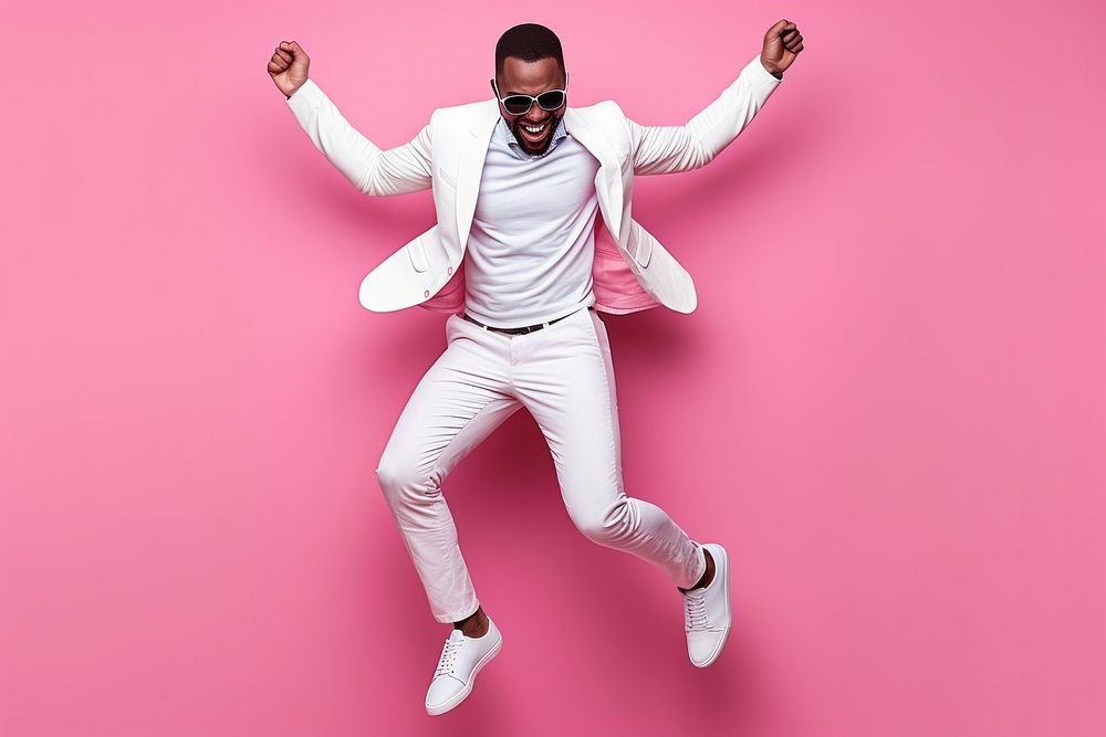 Cool young black man with fashionable clothing style full body on colored background dancing adult fun.