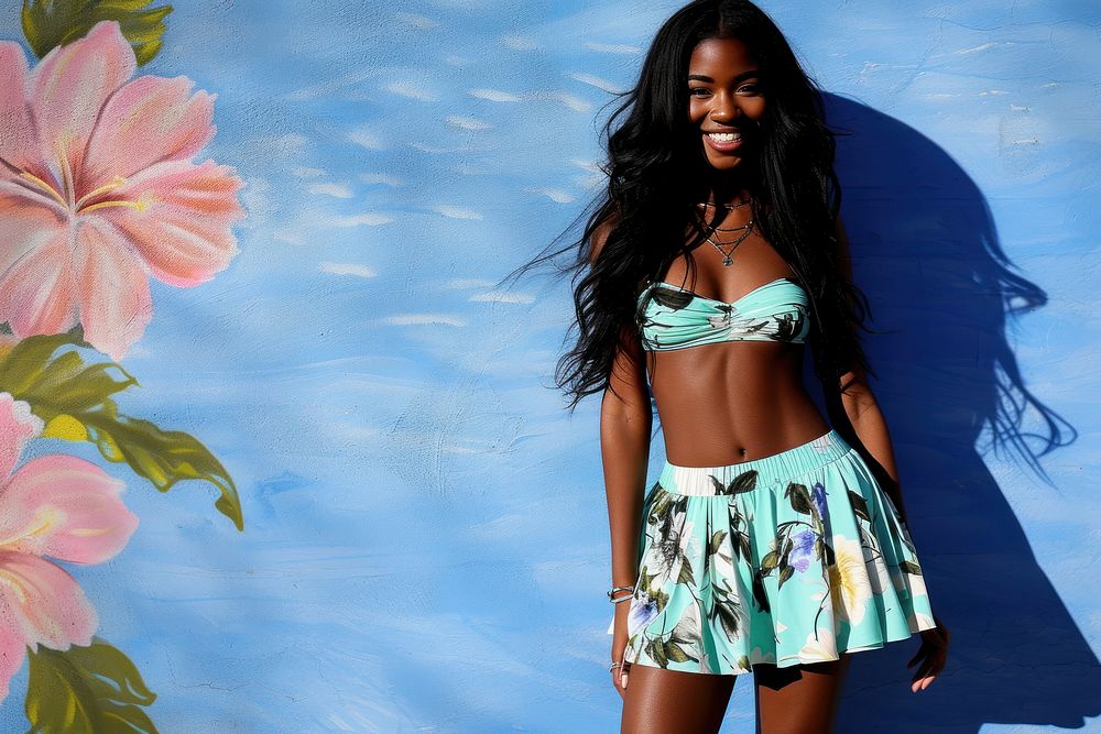 Cool young black woman with fashionable clothing style full body on colored background swimwear bikini skirt.