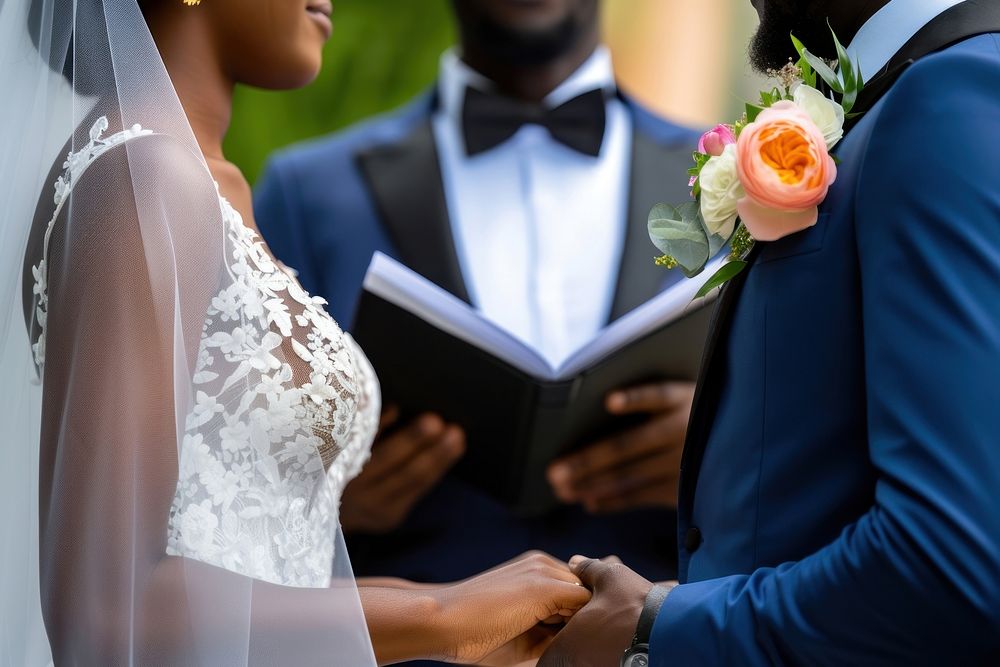 African couple exchanging their vows wedding dress tuxedo.