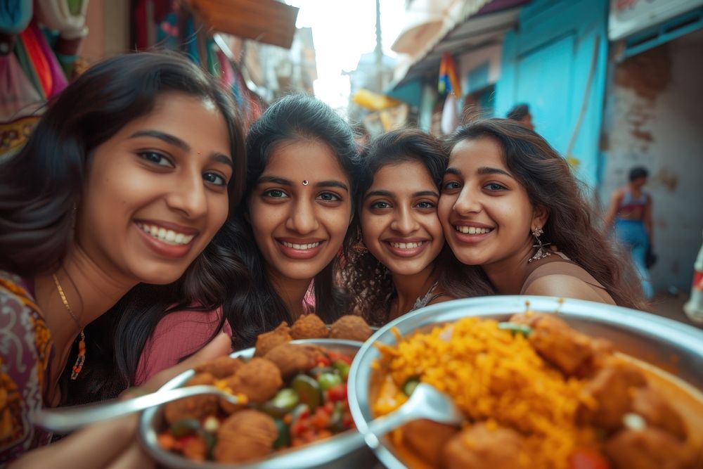 Indian girls eating food smiling adult.