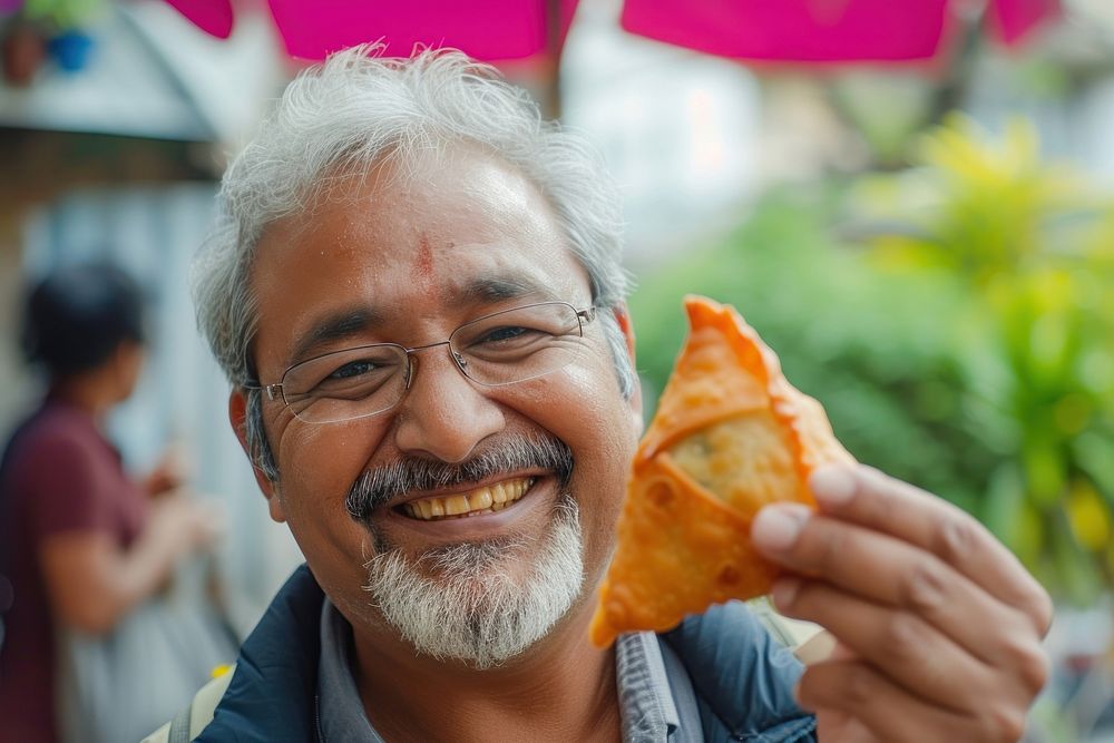Indian uncle eating food smiling glasses.