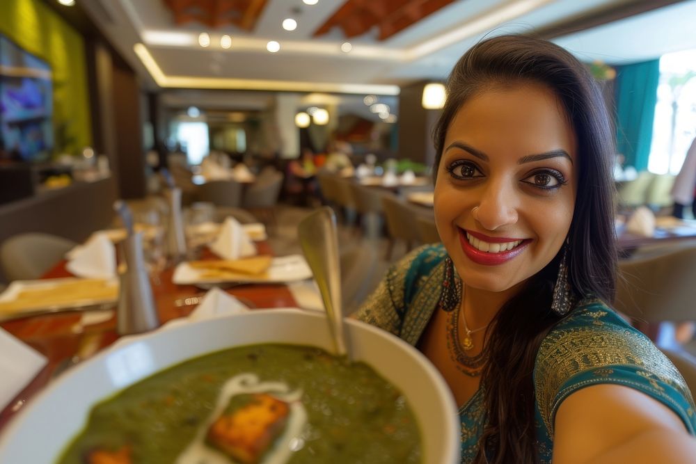 Indian waitress serving food restaurant smiling.