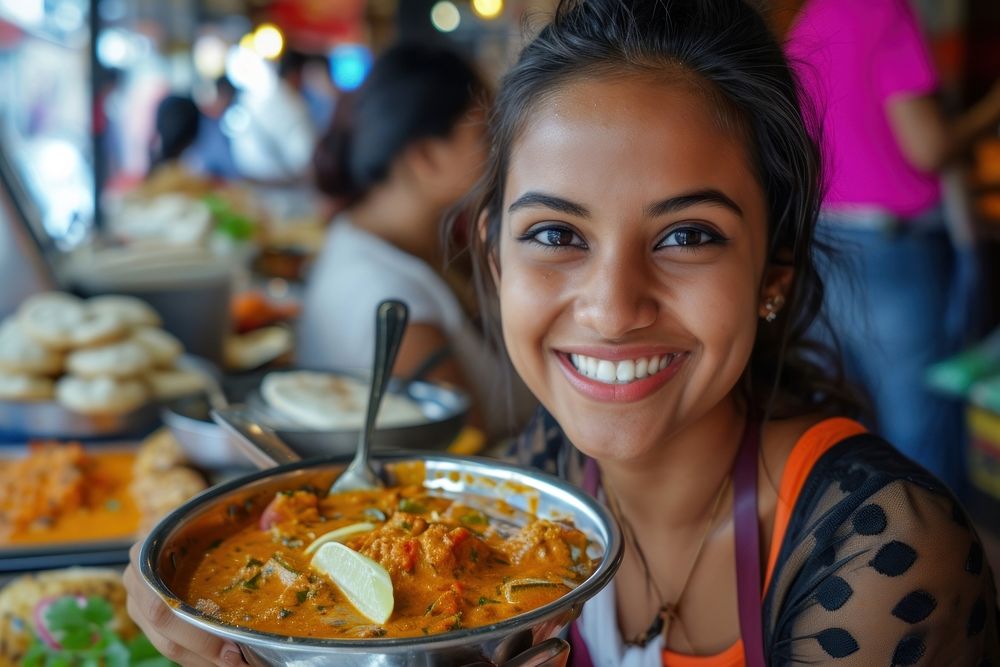 Indian waitress serving food smiling eating.