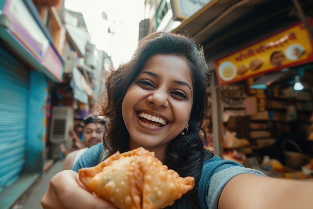 Indian blogger eating food smiling bread.
