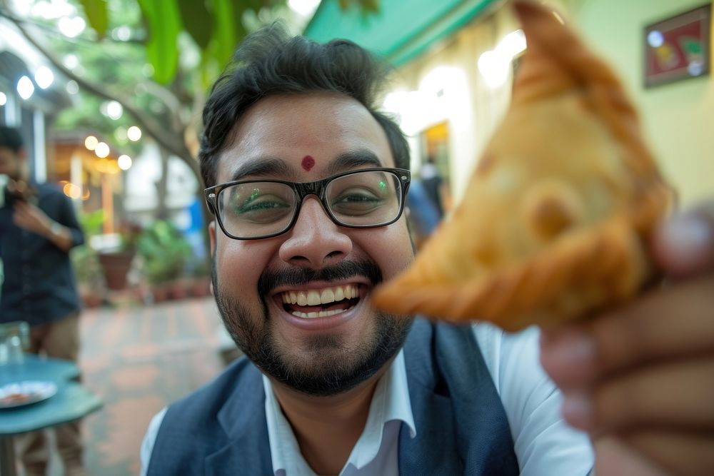 Indian businessman eating food portrait smiling.