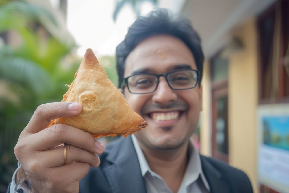 Indian businessman eating food portrait dessert.