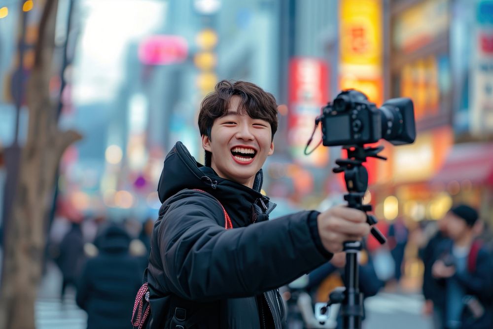 Korean vlogger live on street selfie camera smile.