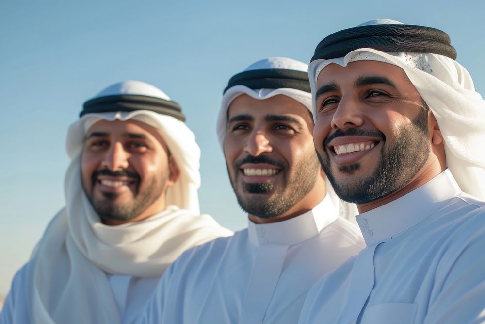 3 Middle eastern men in thawb outdoors smiling people.