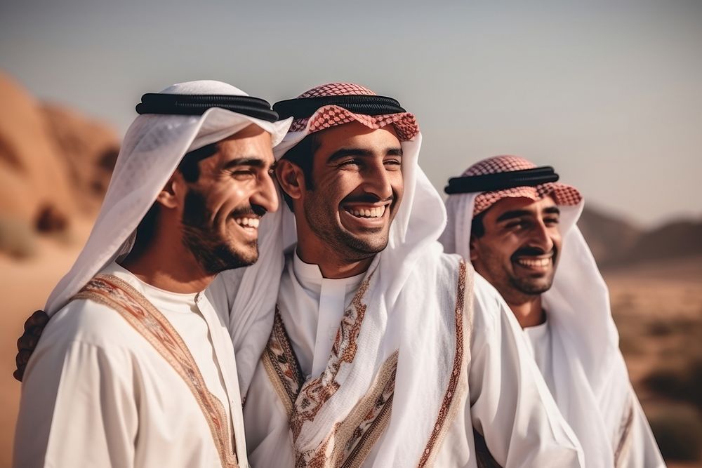 Middle eastern men outdoors smiling desert.