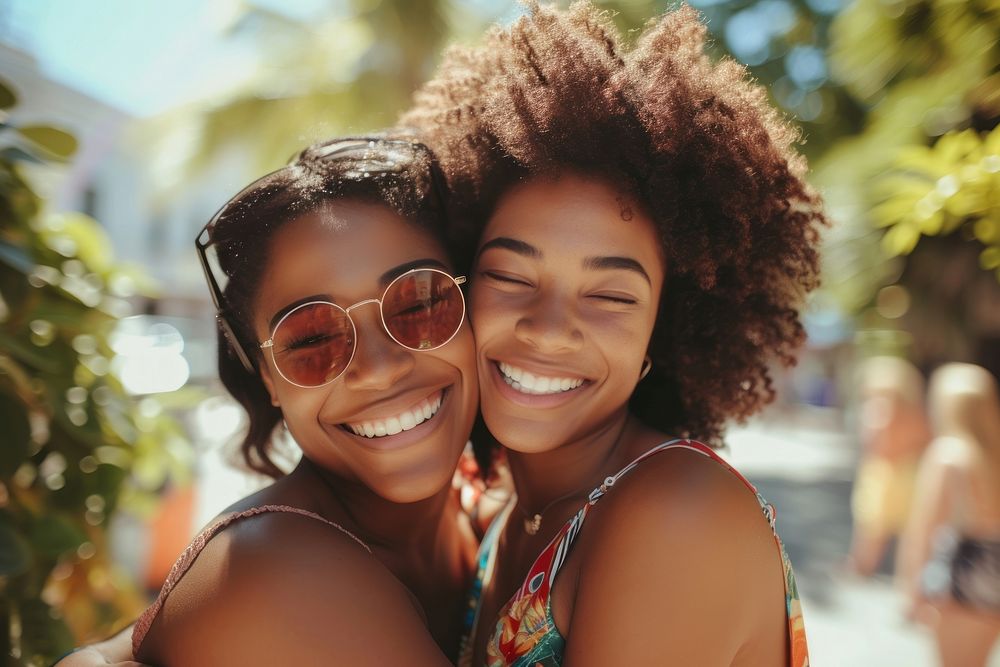 Two happy beautiful young African American women laughing glasses summer.