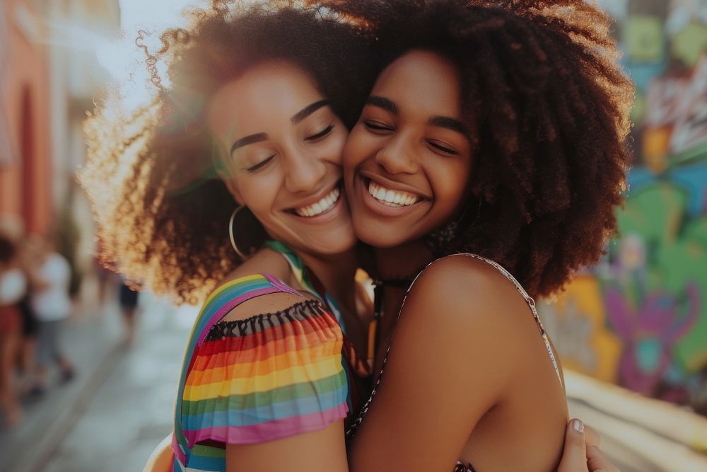 Two happy beautiful young African American lgbtq laughing summer smile.