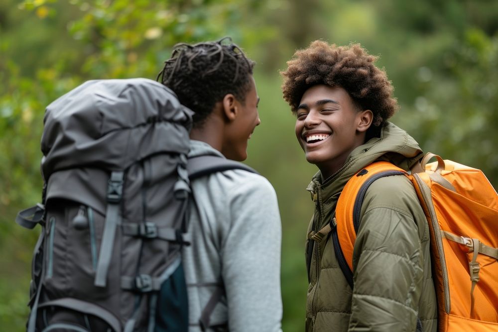 Mixed race teen men backpack backpacking outdoors.