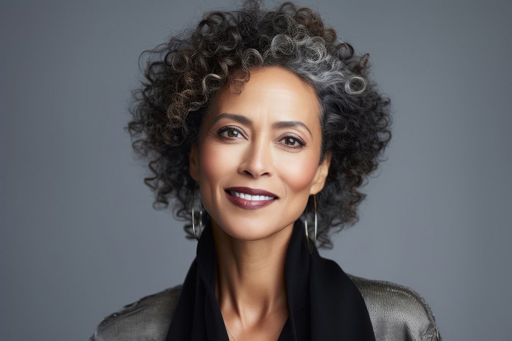 Middle aged multiracial woman wearing natural makeup portrait adult smile.