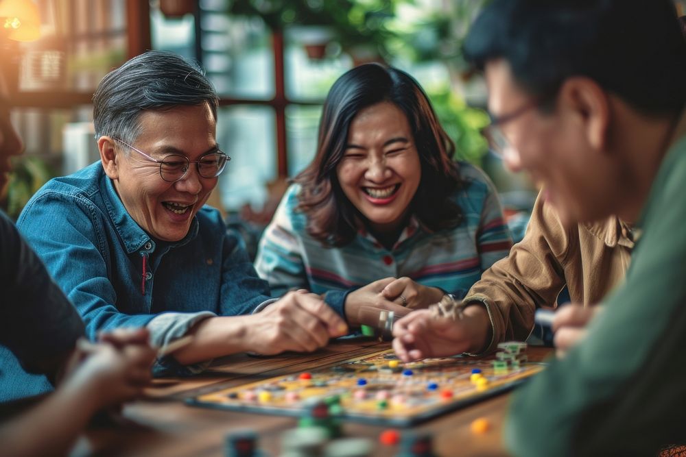Chinese playing board game with friends laughing adult men.