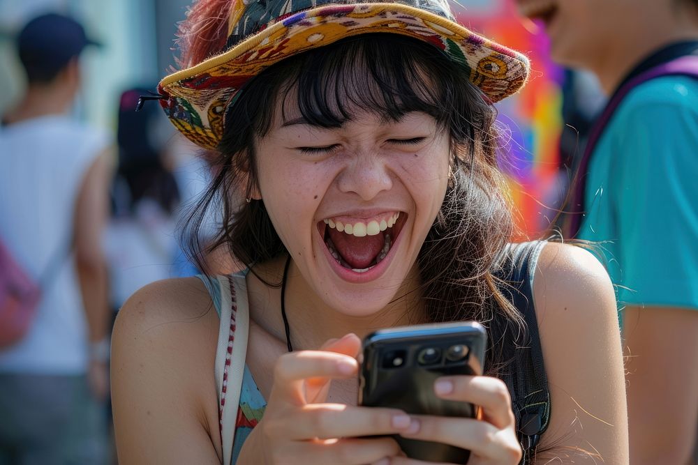 Japannese playing mobile phone laughing adult photo.