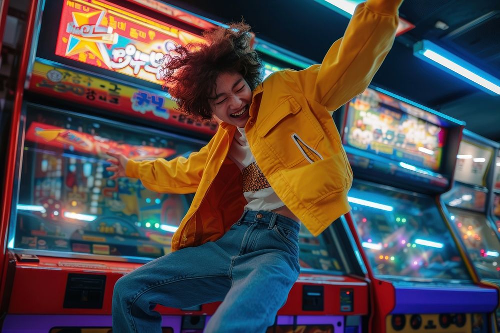 Korean teenager dancing on arcade machine adult electronics happiness.