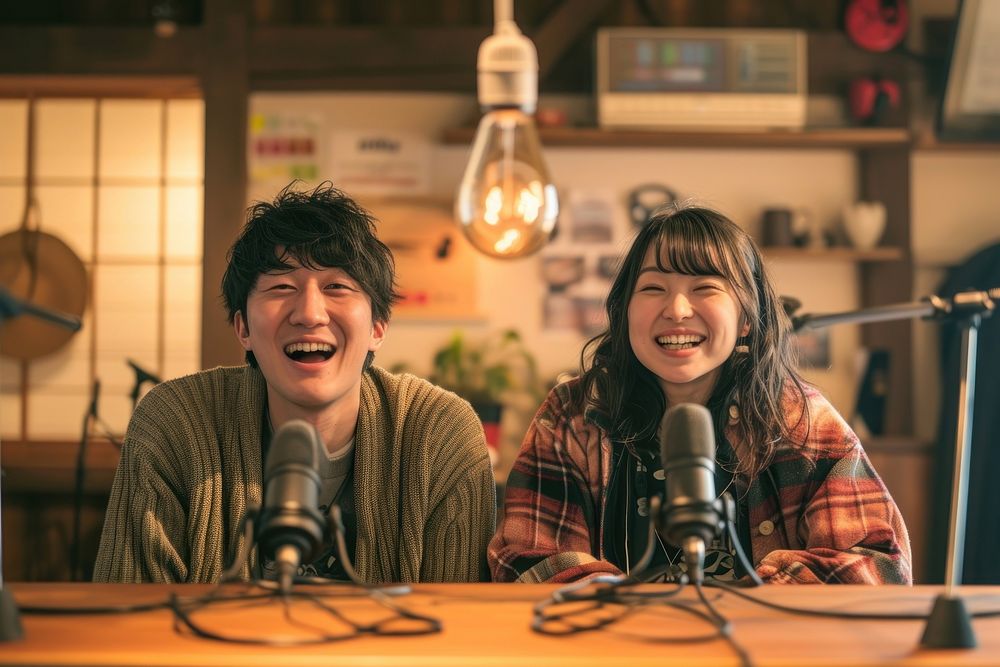 Two Japanese talking podcast microphone togetherness performance.