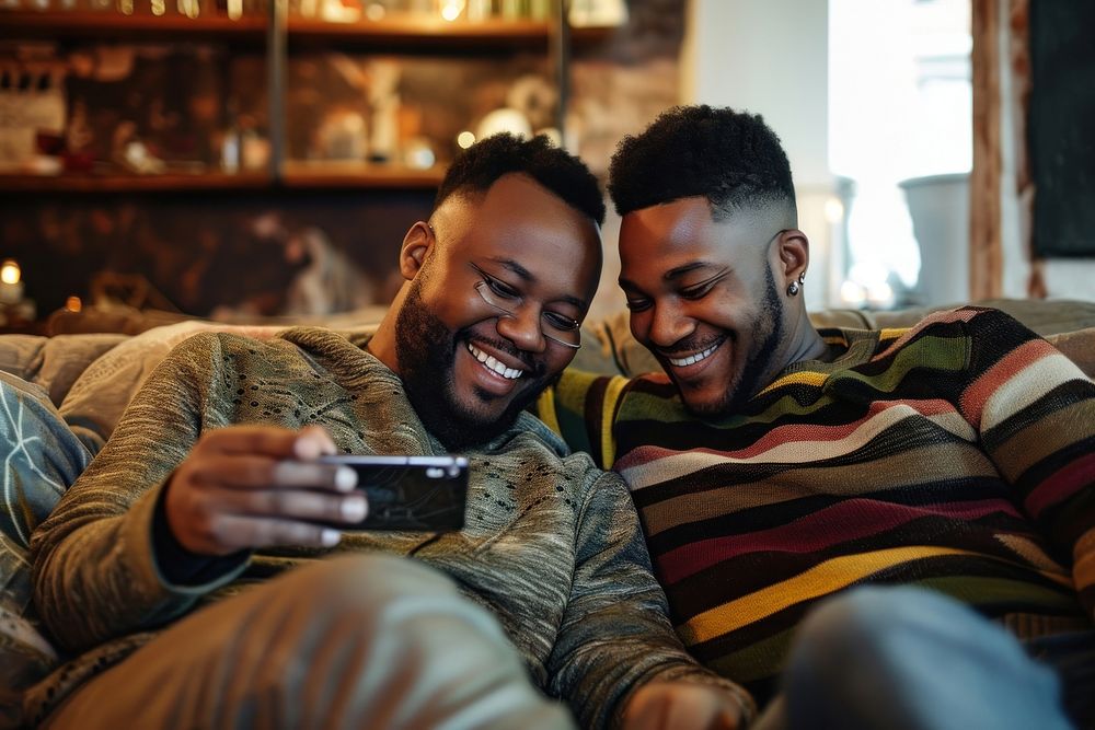 African American Gay couple photography laughing sitting.