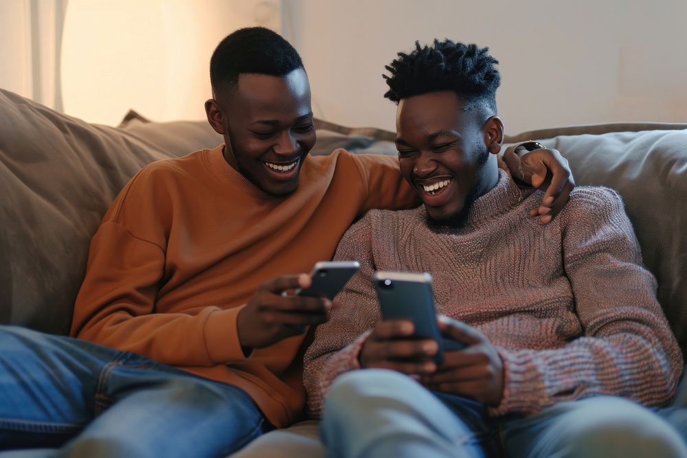 African American Gay couple sitting adult phone.