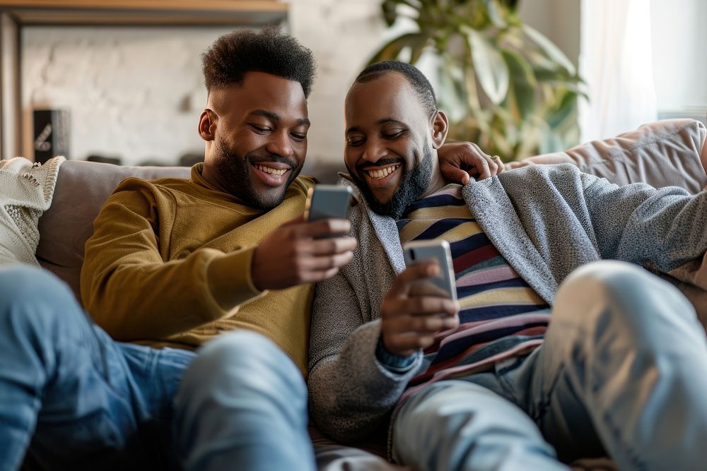 African American Gay couple sitting adult sofa.