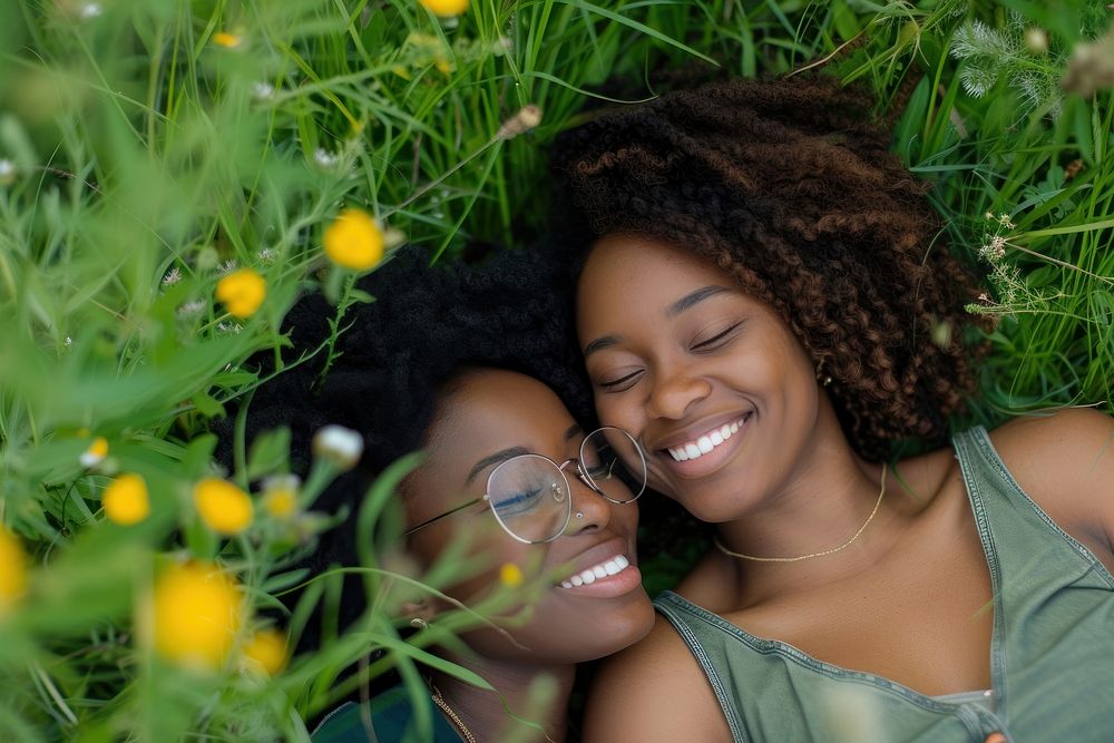 African American Happy lesbian couple relaxing in the grass photography portrait outdoors.