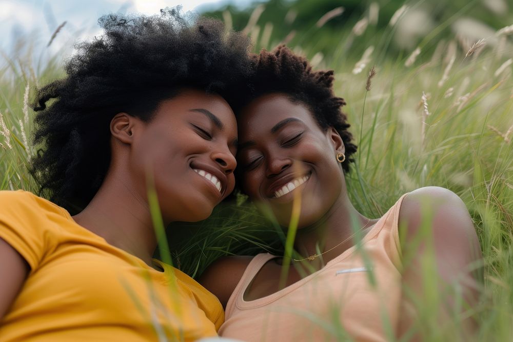 African American Happy lgbtq couple relaxing in the grass laughing smile adult.