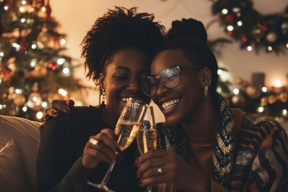 African American lesbian couple christmas champagne drinking.