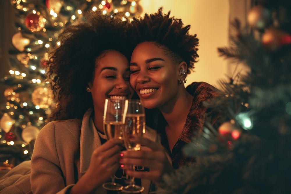 African American lesbian couple champagne drinking smiling.