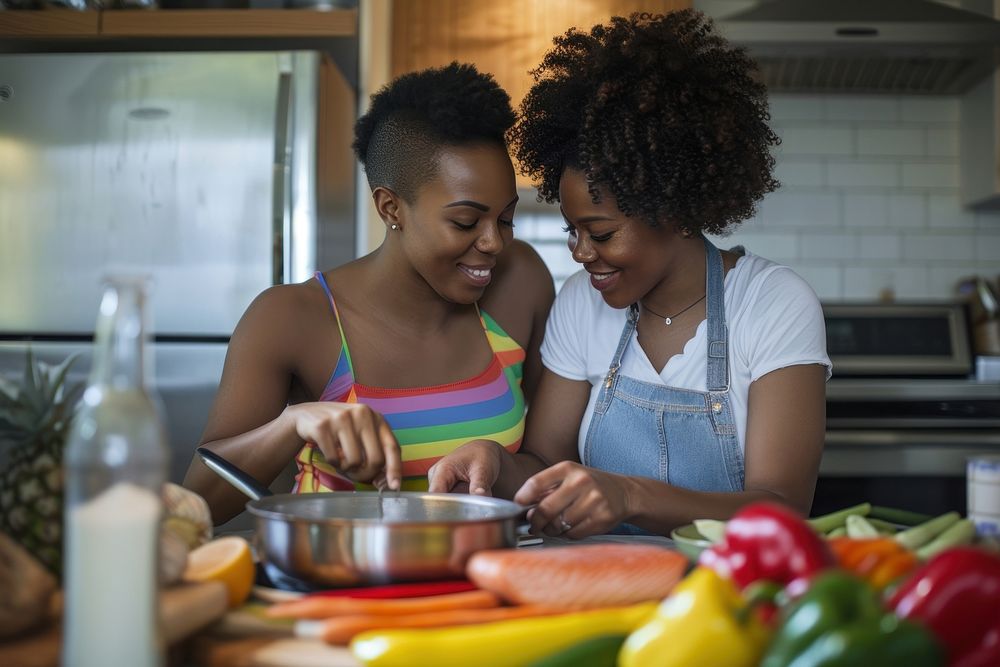 African American lgbtq Couple cooking appliance kitchen.
