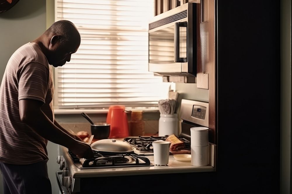 African American man appliance kitchen cooking.