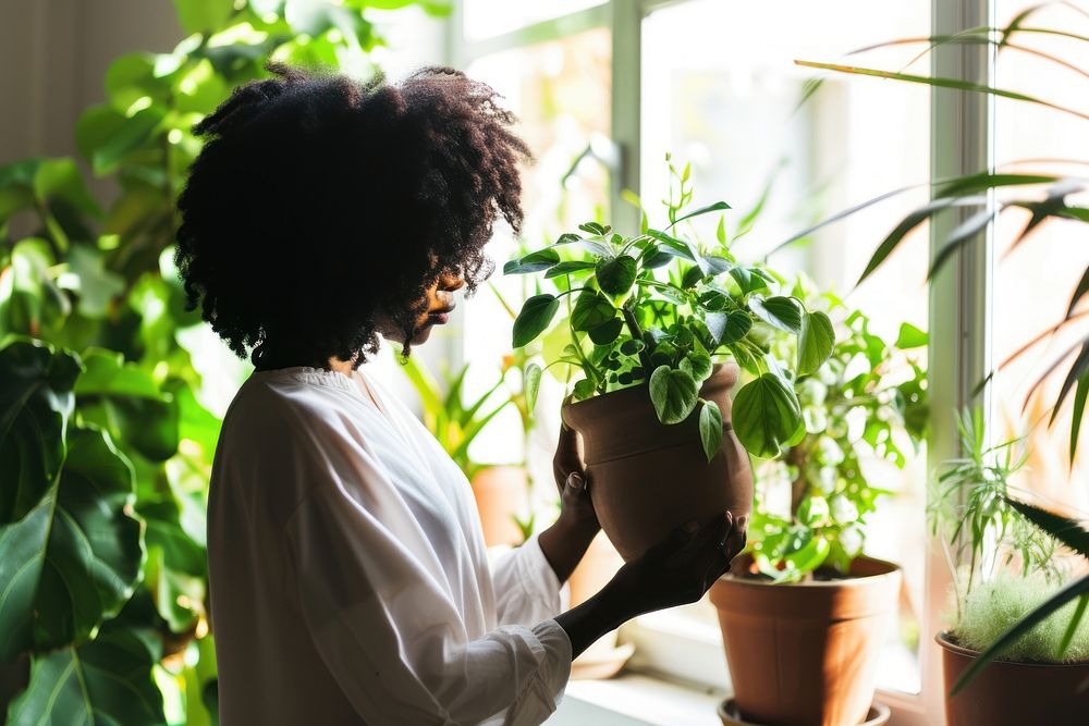 African American woman plant adult pot.