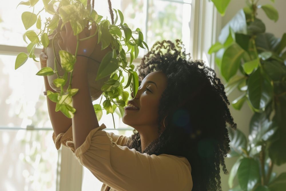 African American woman plant adult contemplation.