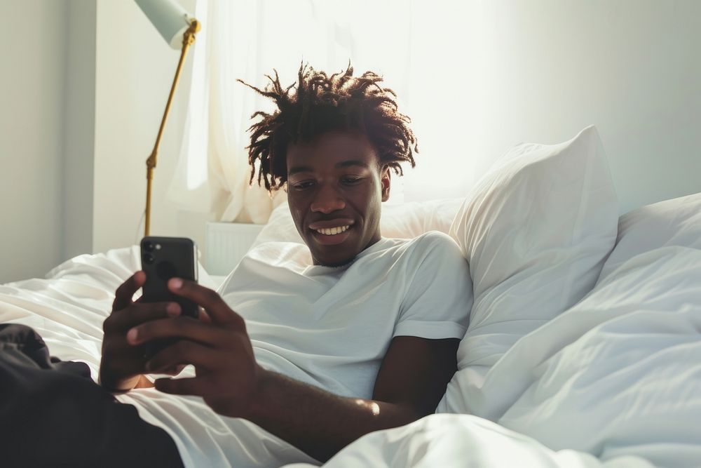 African American young man bedroom adult phone.
