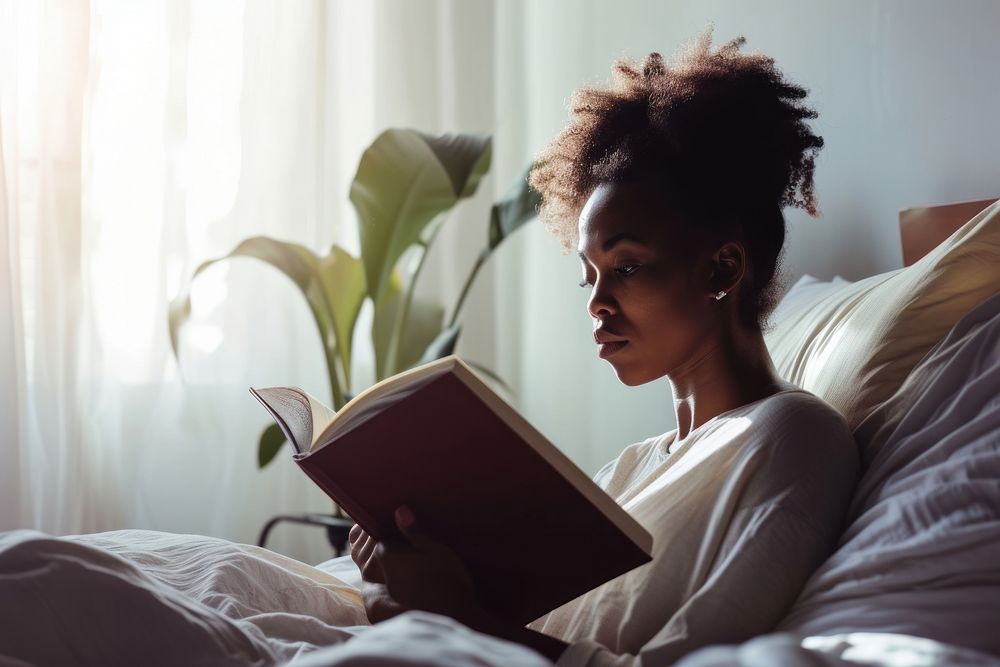 African American young woman reading bedroom adult.