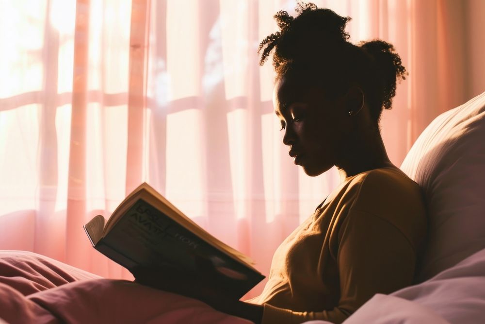 African American young woman reading bedroom adult.