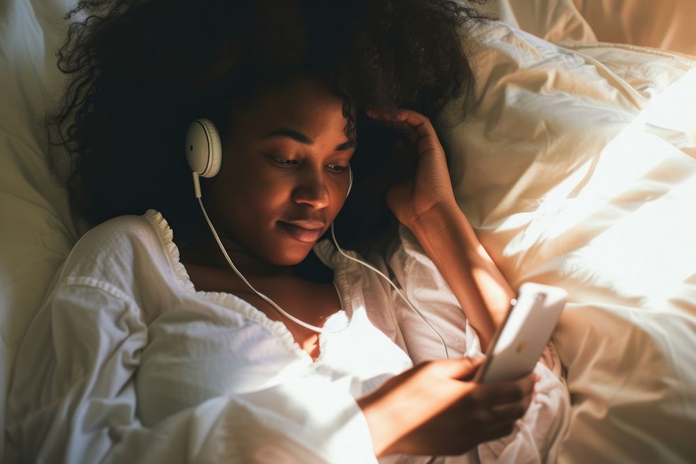 African American young woman listening bedroom adult.