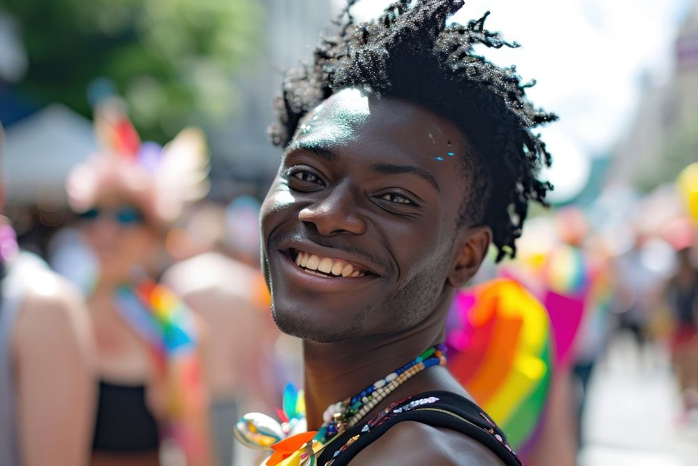 Handsome smiling black skin guy queer at LGBT parade outdoor photography carnival portrait.