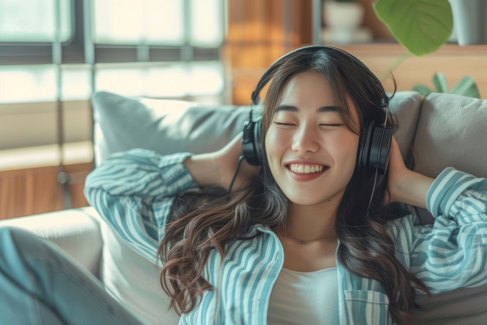 East asian female smile headphones listening.