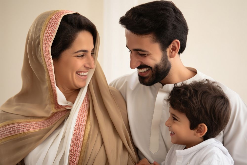 Middle eastern father and mother and son smiling at each other family people adult.