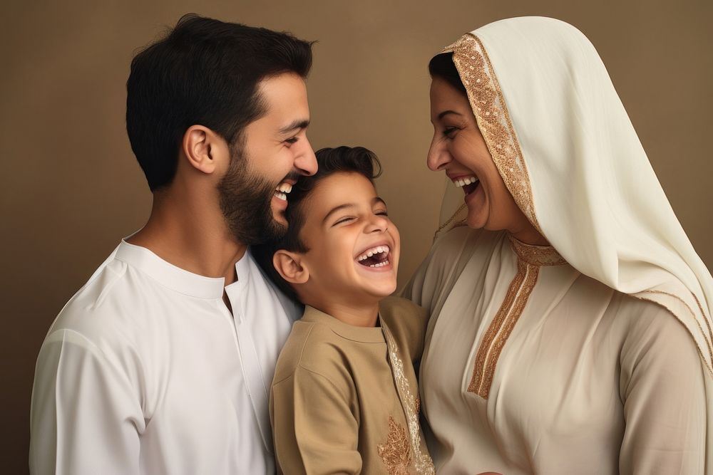 Middle eastern father and mother and son smiling at each other laughing family people.