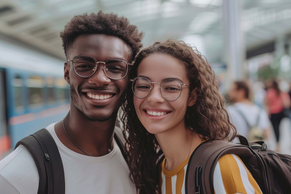 Mixed race couple with backpack smiling glasses travel.